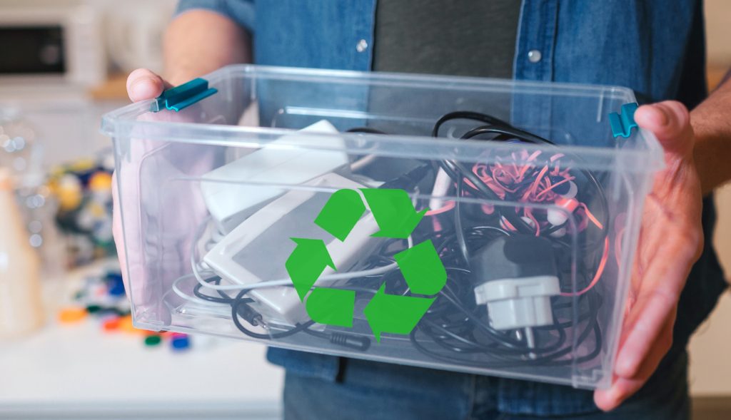 Man holding container of outdated technology for recycling